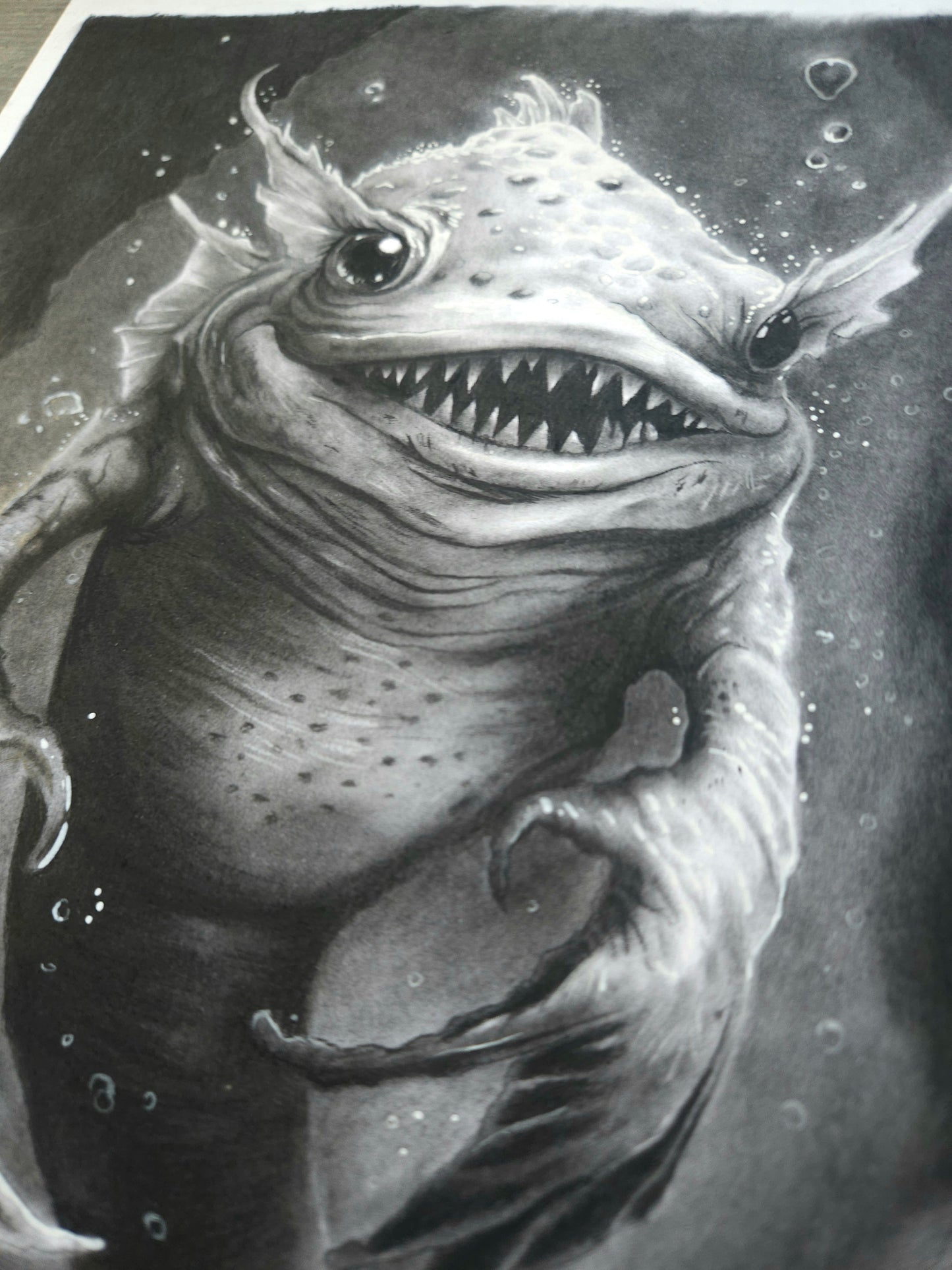 Dark fantasy charcoal artwork “Smiler from the Depths” by S.A.D Illustration, creepy monster portrait with glowing eyes and unsettling smile.